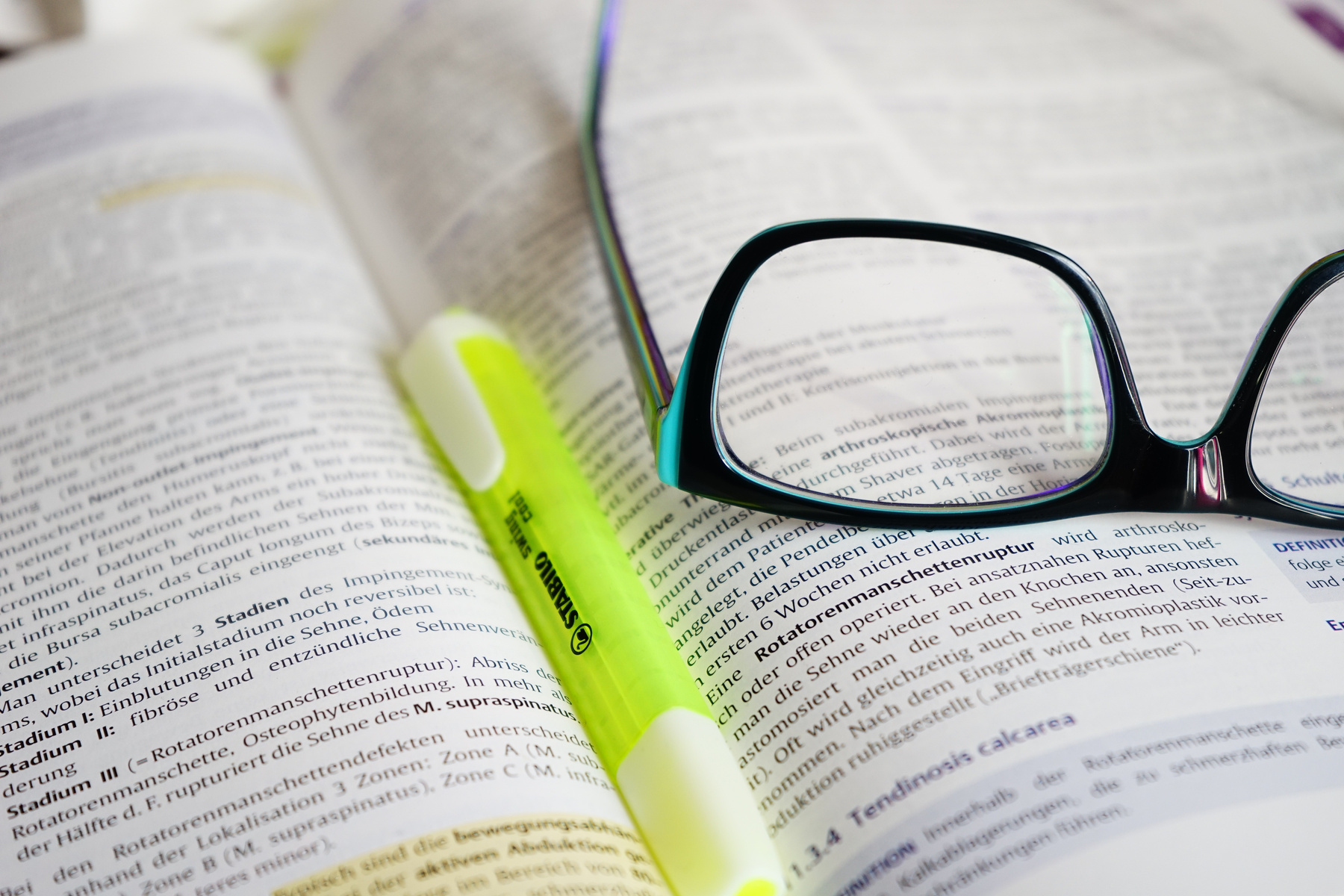 Reading Glasses and Pen on a Open Book